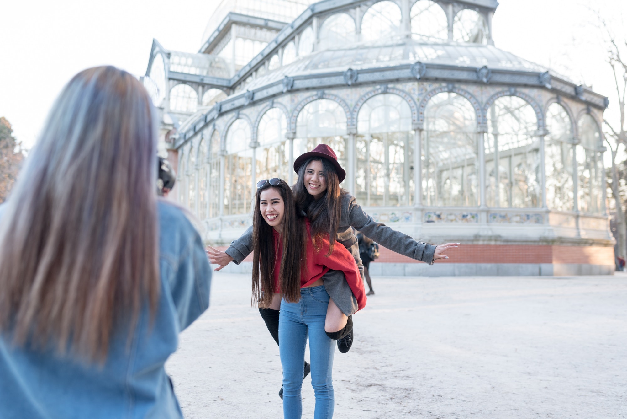 Philippine friends women taking photos and selfie in Retiro Park Madrid
